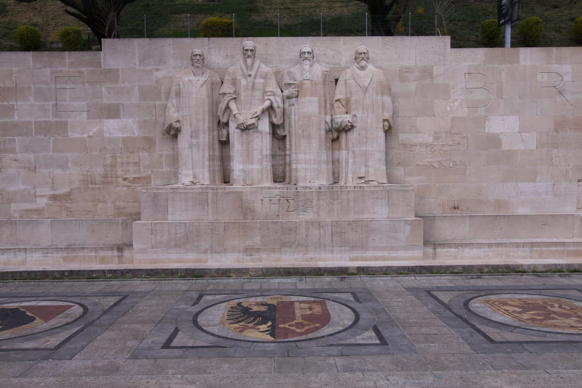 Mur des Réformateurs au Parc des Bastions à Genève, figures dressées du dialogue et de la fermeté, image de la négociation.